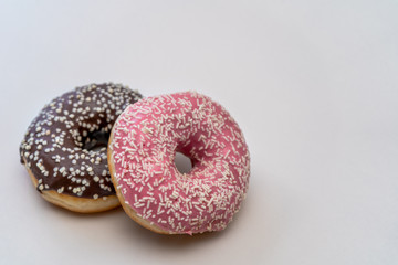 Close-up. Fresh tasty chocolate and pink fruit donut isolated on white background