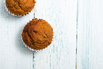 pair of chocolate muffins on white table