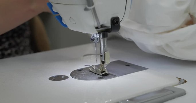 The Girl Is Sewing On The Sewing Machine