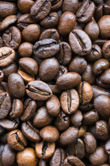 Background of roasted coffee beans scattered on the table.
