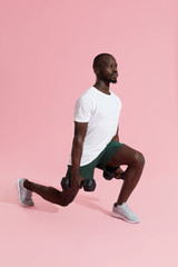 Workout. Sports man exercising, doing lunge with dumbbells