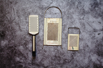 Fototapeta premium Metal graters on a gray background..Horizontal