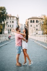 Happy couple at dawn strolling in Italy. Morning summer photo shoot in Rome.