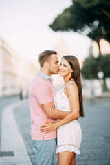 Obraz premium Happy couple at dawn strolling in Italy. Morning summer photo shoot in Rome.