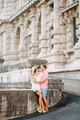 Fototapeta na wymiar Happy couple at dawn strolling in Italy. Morning summer photo shoot in Rome.