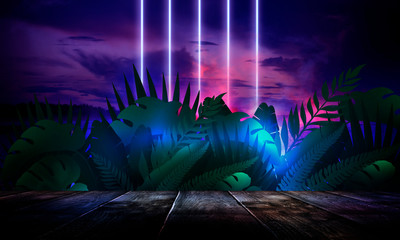 Dark empty room, wooden table, brick walls. Tropical leaves, neon light. Night view.