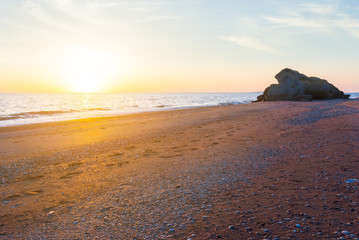 quiet sandy sea beach at the sunset, evening sea scene
