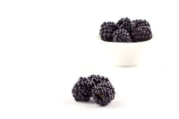 Blackberries berries on a saucer isolated on a white background.