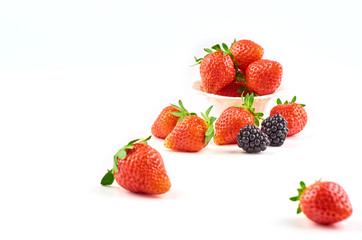 Composition of strawberries, blackberries, blueberries, raspberries and red currants on a white background.