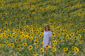 Fototapeta premium Woman in a sunflower field, Provence, France