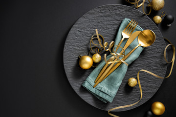 Gold cutlery served on plate for Christmas Dinner