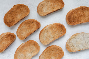 Toasted baguette slice isolated on white background close up. Toast, crouton. Top view.