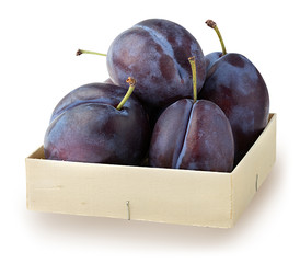 Fresh plums in a wooden box isolated on white background with clipping path