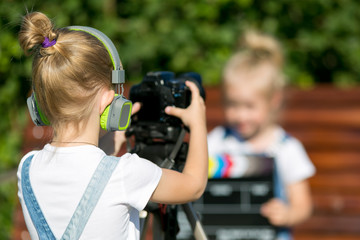 Children with photo appart in a city park Two girls on the street make a video for the Internet,...