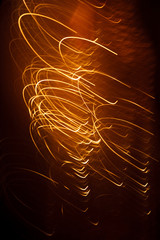 Abstract background orange stripes from sparks on a dark background.