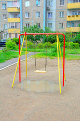 Children's playground after rain in the usual courtyard of an apartment building. provincial town. summer. Russia