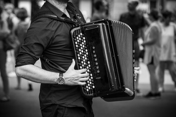 closeup of hands of accordionist playing accordion in the street - obrazy, fototapety, plakaty
