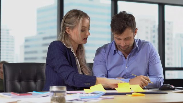 Group of  business people men and woman working together with paper document file or Memo notes or post it   in meeting room.teamwork discussing in office , talking , debate , analyze , select