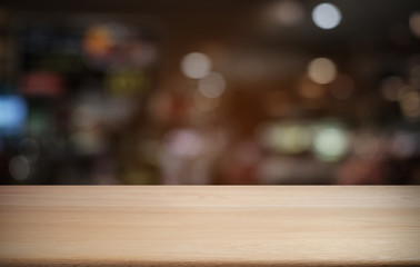 Empty dark wooden table in front of abstract blurred bokeh background of restaurant . can be used for display or montage your products.Mock up for space.