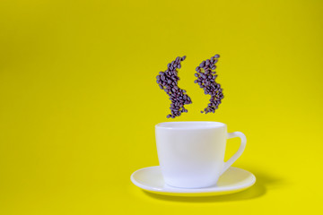 Coffee in a white cup on a yellow background