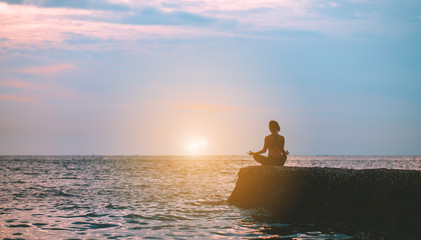 Silhouette yoga woman practice at beach relaxation in class exercise with pose fitness sport for healthy lifestyle and seaside freedom vacation at sunset in summer.
