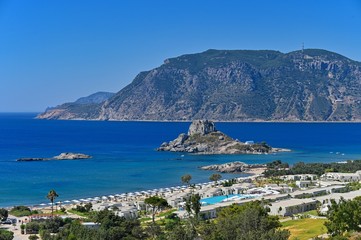 Fototapeta na wymiar Beautiful beach with sea in tourist resort. Greece island Kos. Beautiful concept for summer vacation. Natural colorful background.
