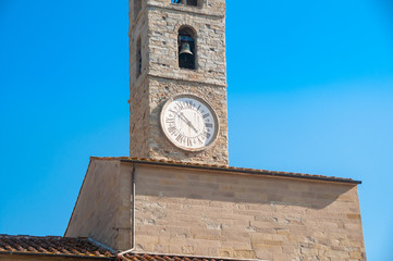 Bell tower with bell and clock with Roman figures