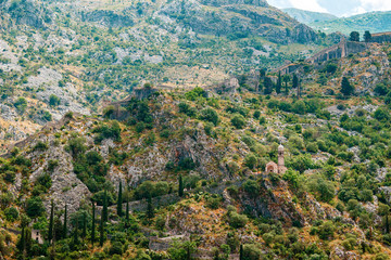 Defense wall and Catholic church in the high mountains above the old town Kotor, Montenegro