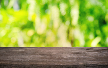 Fototapeta premium Empty dark wooden table in front of abstract blurred bokeh background of restaurant . can be used for display or montage your products.Mock up for space.