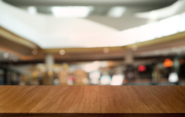Obraz premium Empty dark wooden table in front of abstract blurred bokeh background of restaurant . can be used for display or montage your products.Mock up for space.