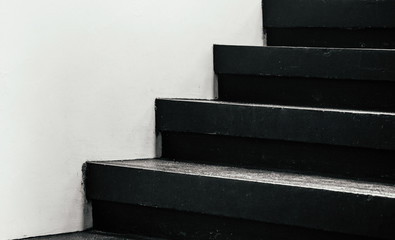 Black stairway steps with white wall - dark shadow monotone image