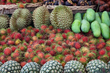 Fototapeta premium Stack of fruits that are lined up with rambutan, mango, durian, pineapple.