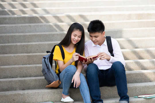boy and girl friend sitting the stair reading book