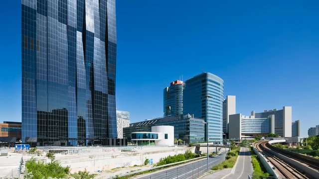 The Vienna International Centre and Donau City Tower with a subway train moving towards the camera.