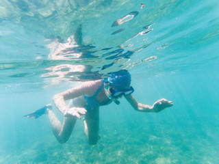 woman snorkeling in clear tropical waters - active holiday