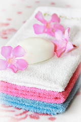 Fototapeta na wymiar multi-colored cotton white blue pink bath towels for the bathroom