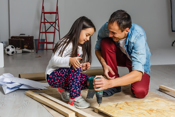 father and daughter make repairs at home