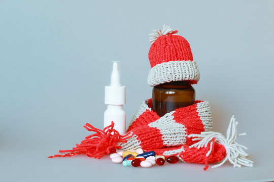  a bottle of syrup dressed in a scarf and cap in the season of colds