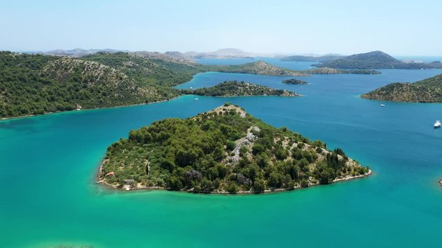 Beautiful small islands in archipelago in nature park Telascica on the island of Dugi Otok in Croatia, aerial seascape, circle drone shot