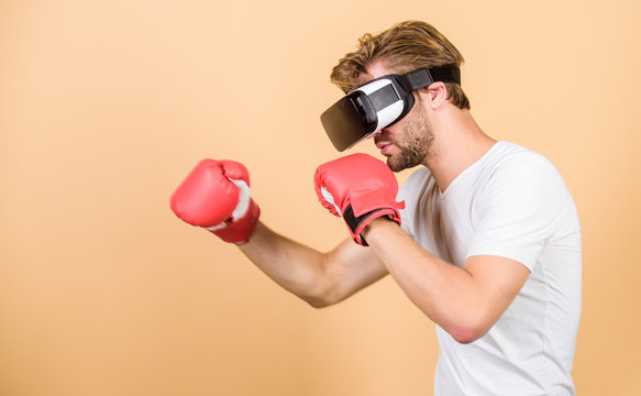 Cyber coach online training. Explore cyber space. Augmented 3D world. Cyber sportsman boxing gloves. Man play game in VR glasses. Cyber sport concept. Man boxer virtual reality headset simulation