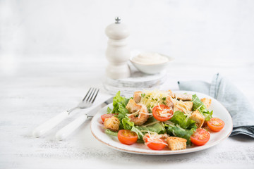 Traditional Italian Caesar salad with chicken, tomatoes and Parmesan
