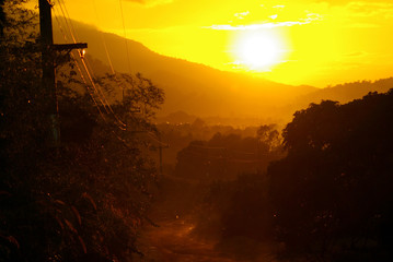 Sunlight of sunset and a dirt road in the countryside