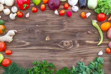  On a brown wooden background fresh vegetables from the garden, for a healthy diet.Copy space.    