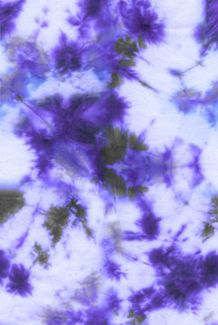 Abstract tie-dye hand painted fabric background with irregular floral spots