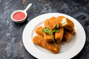 Kurkuri paneer fingers or pakora/pakoda snacks also known as Crispy Cottage Cheese Bars, served with tomato ketchup as a starter. selective focus