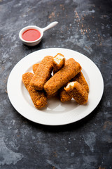 Kurkuri paneer fingers or pakora/pakoda snacks also known as Crispy Cottage Cheese Bars, served with tomato ketchup as a starter. selective focus