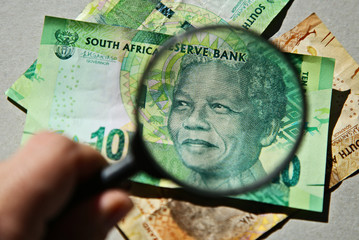 South African money concept image consisting of a magnifying glass and a 10 rand note. 
