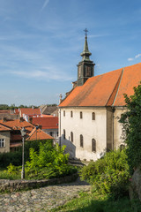 Fototapeta na wymiar Petrovaradin, Serbia - July 17. 2019: Petrovaradin fortress; Roman Catholic church of st Juraj; View from the steps of the fortress