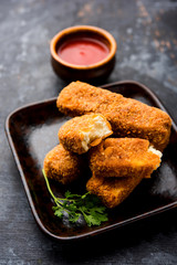 Kurkuri paneer fingers or pakora/pakoda snacks also known as Crispy Cottage Cheese Bars, served with tomato ketchup as a starter. selective focus