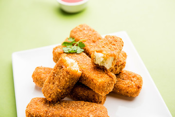 Kurkuri paneer fingers or pakora/pakoda snacks also known as Crispy Cottage Cheese Bars, served with tomato ketchup as a starter. selective focus